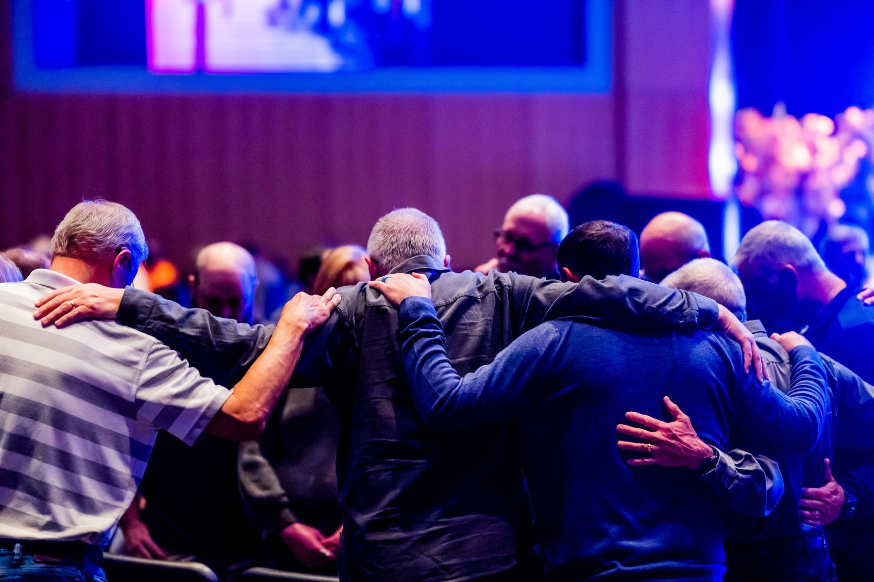 Friends embracing during worship